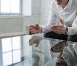 Professional consultant discussing solutions during a meeting indoors.